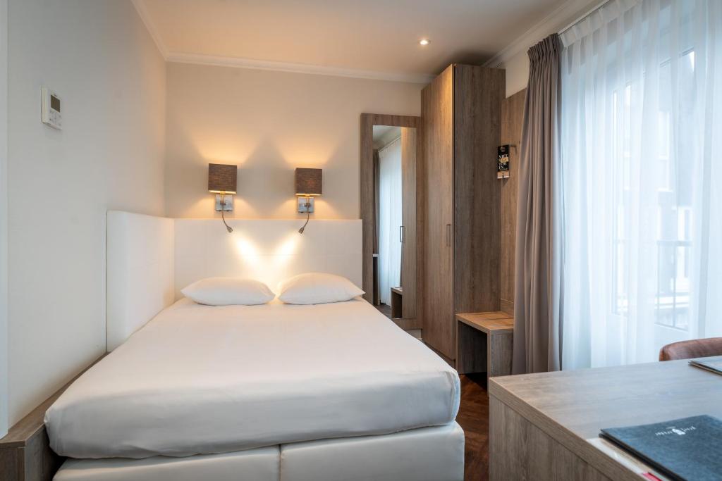 Postel nebo postele na pokoji v ubytování Hotel De Lindeboom