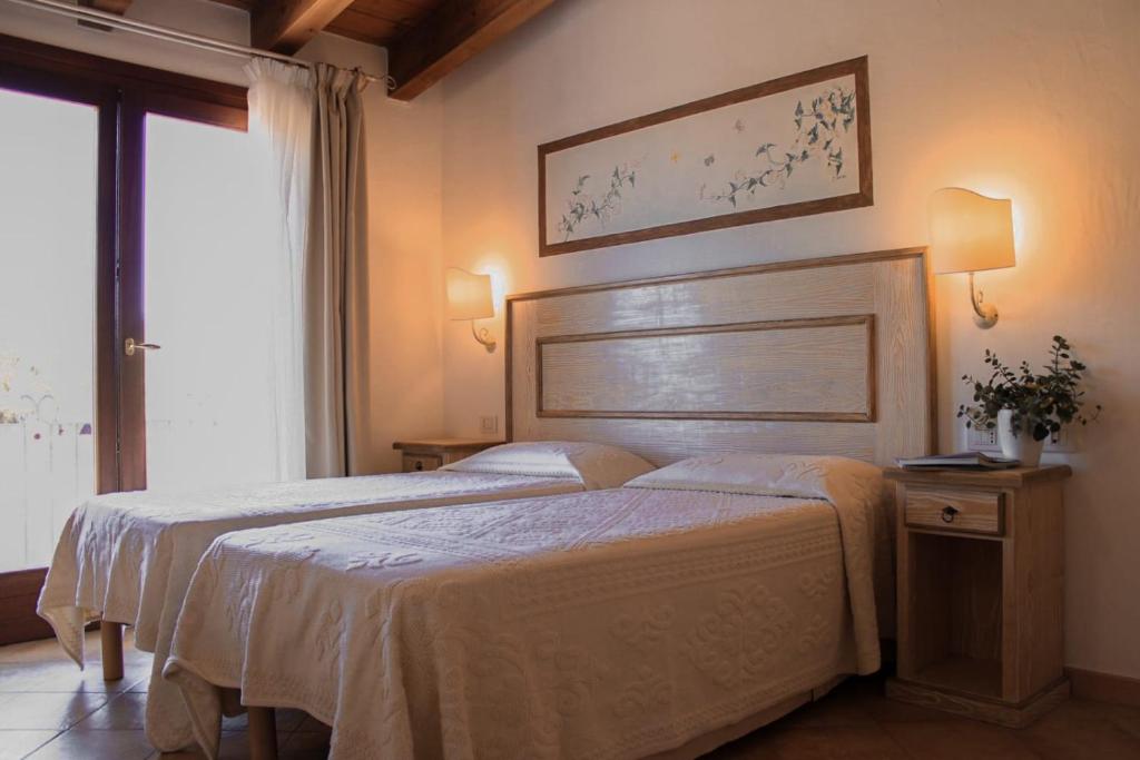 Postel nebo postele na pokoji v ubytování Hotel La Borgata