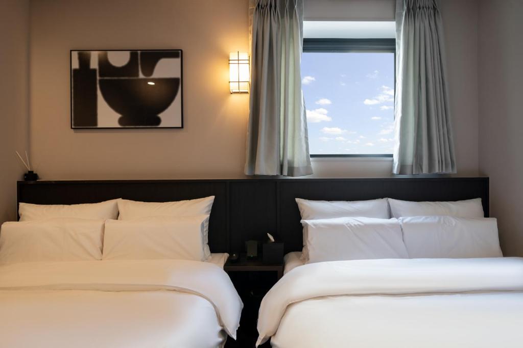 Postel nebo postele na pokoji v ubytování Aank Ryokan Hotel Paju