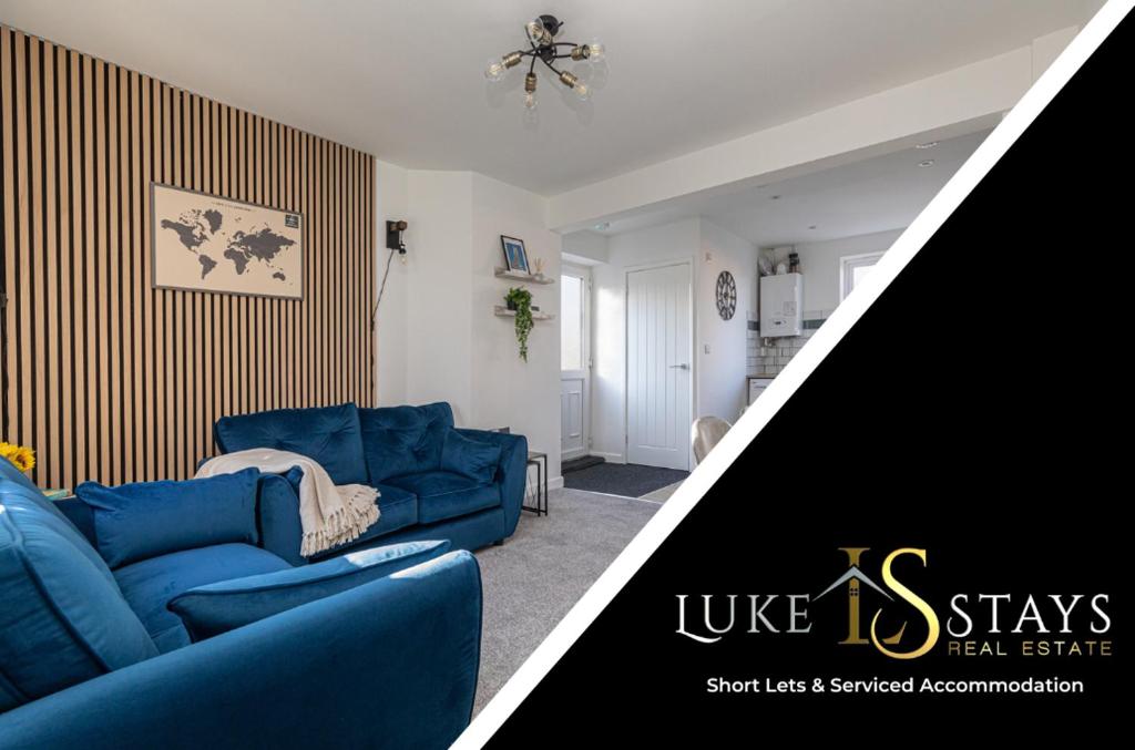a living room with a blue couch and a living room with at Luke Stays - Finchale Ave in Sheepscar