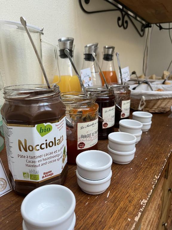 a table with jars of food and white bowls at Hotel d'Aragon - Place de la Comédie in Montpellier