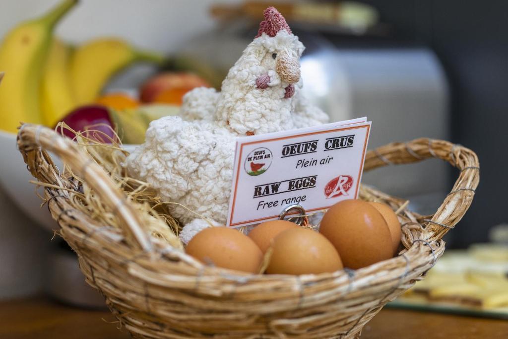 a basket of eggs with a stuffed animal in it at Hotel d'Aragon - Place de la Comédie in Montpellier