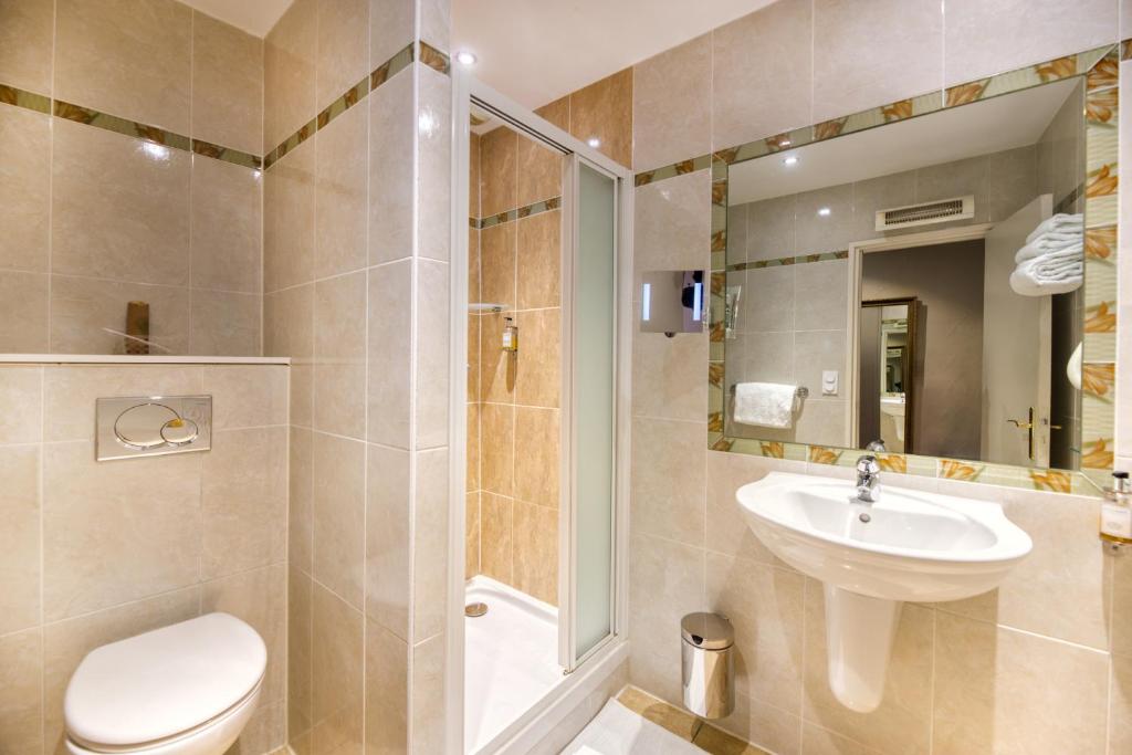 a bathroom with a toilet and a sink and a shower at Hotel d'Aragon - Place de la Comédie in Montpellier