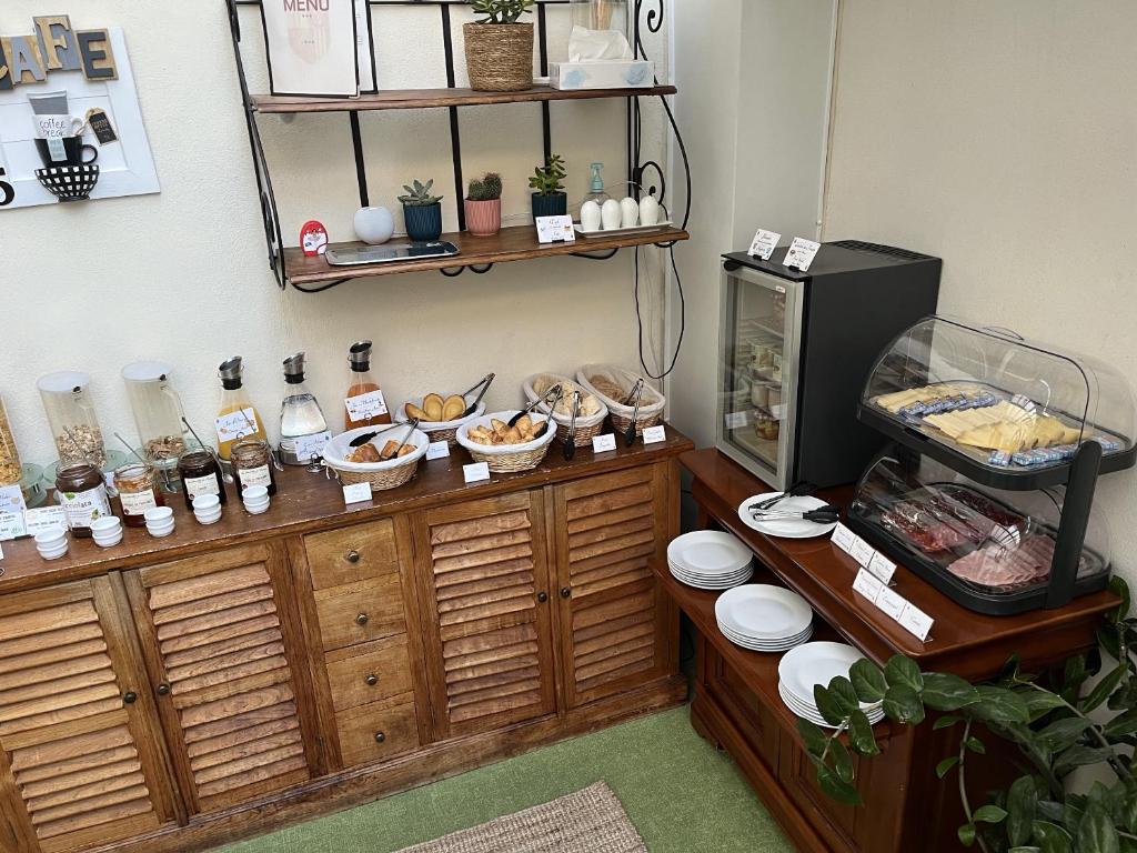 a room with a counter with bowls of food at Hotel d'Aragon - Place de la Comédie in Montpellier