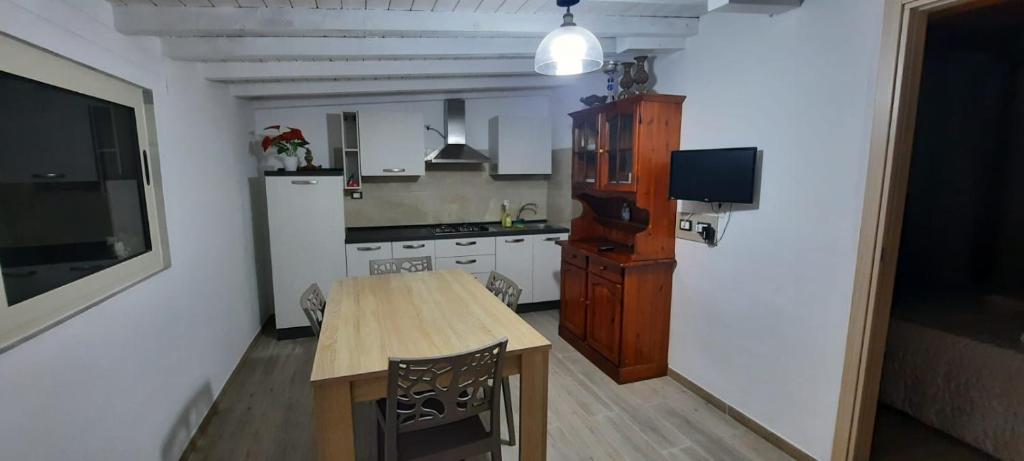 a kitchen with a wooden table and a refrigerator at Mission Relax 4 in Lampedusa