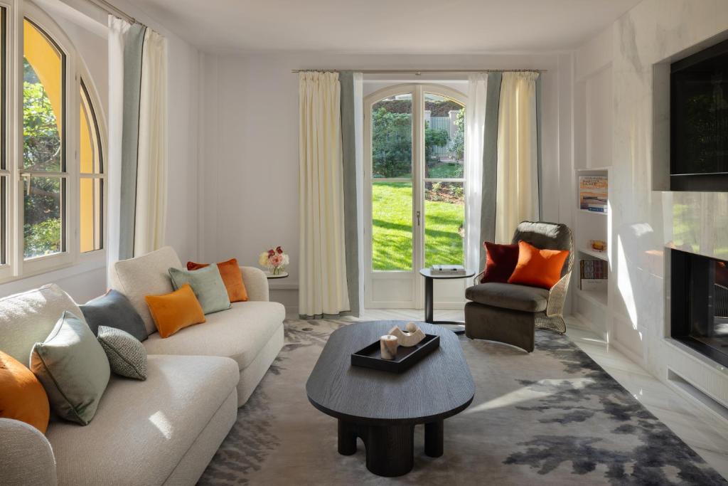 a living room with a couch and a table at Grand-Hôtel du Cap-Ferrat, A Four Seasons Hotel in Saint-Jean-Cap-Ferrat
