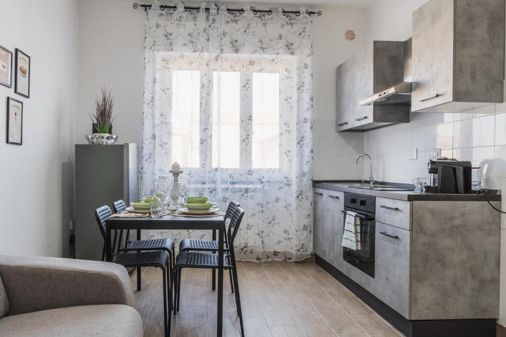 a kitchen with a table and chairs in a kitchen at Enjoy and Fly in Fiumicino