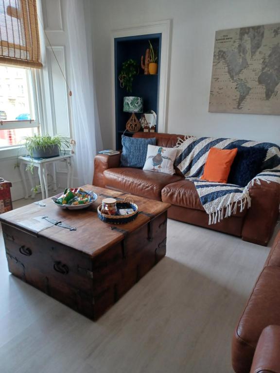 a living room with a couch and a coffee table at The Fuzzy Duck in Broughty Ferry