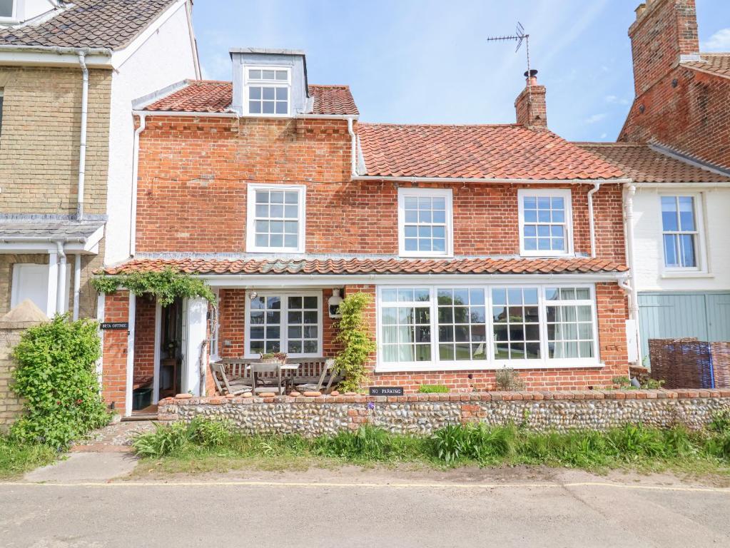 a red brick house with white windows at Beta Cottage in Southwold