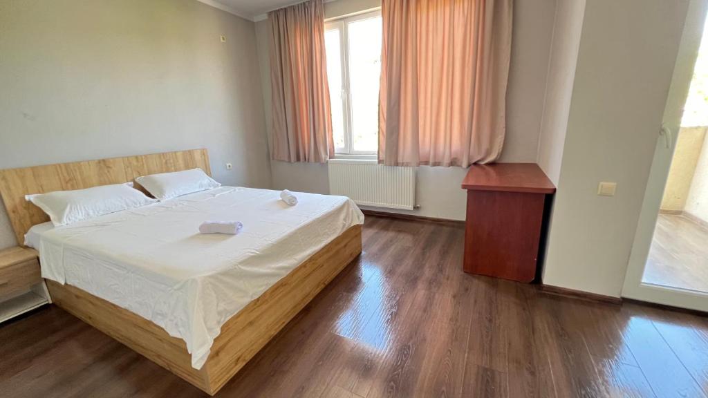 a bedroom with a large bed and a wooden floor at Garden House Tbilisi in Tbilisi City