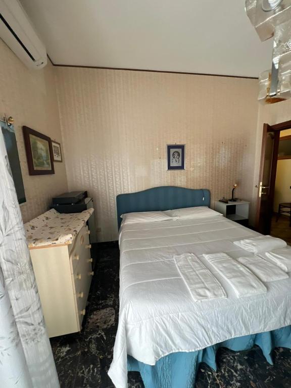 a bedroom with a bed and a dresser in it at Affittacamere da Elio e Renata in Calvi dellʼ Umbria