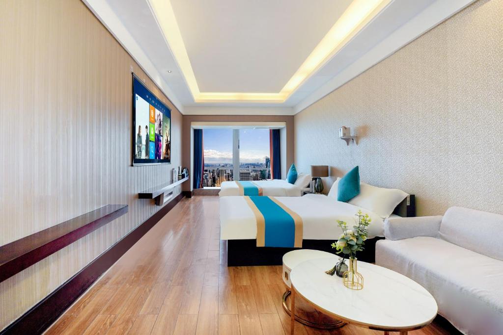 TV a/nebo společenská místnost v ubytování HT Legend Hotel Changgang Metro Station Exit F -Direct to Canton Fair
