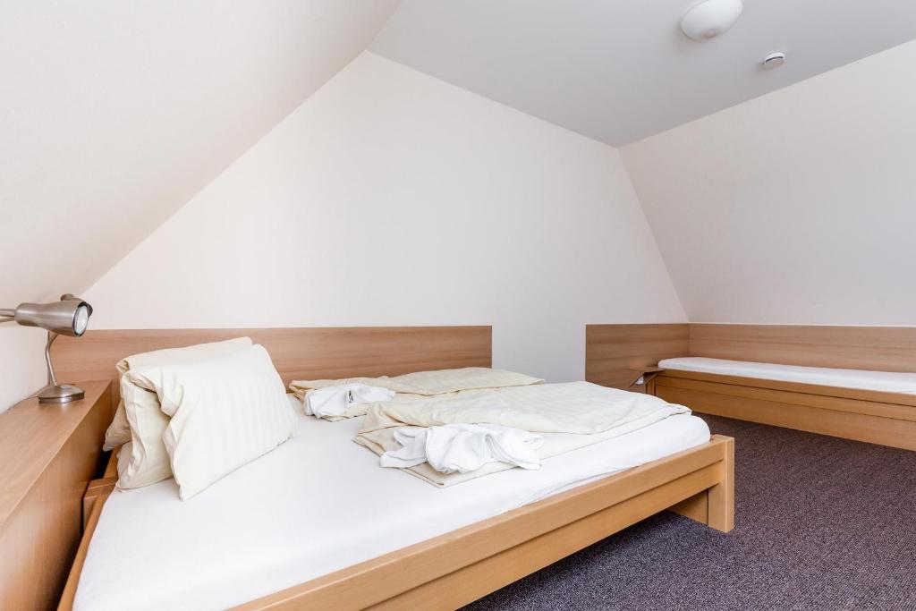 Postel nebo postele na pokoji v ubytování Penzion a Apartmány Daro
