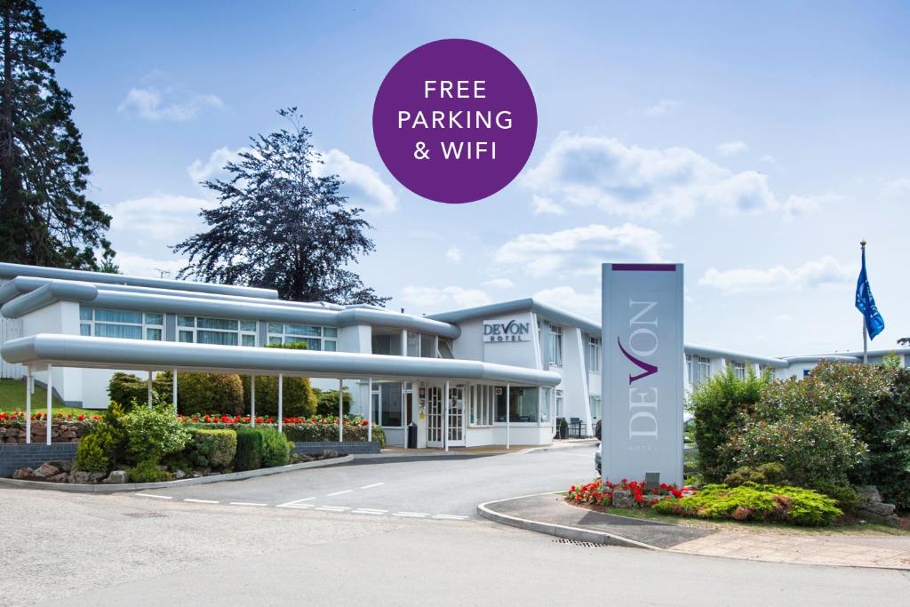 a building with a sign that reads free parking and wifi at The Devon Hotel in Exeter