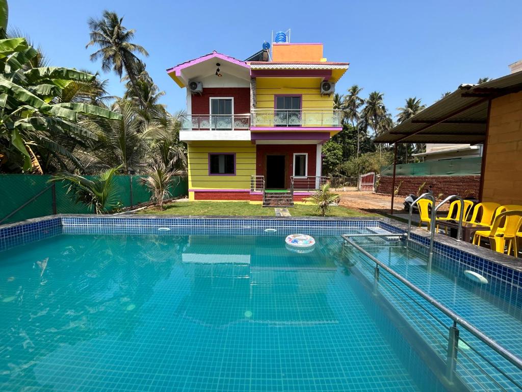 a house with a swimming pool in front of a house at Anand Heritage Villa in Nagaon