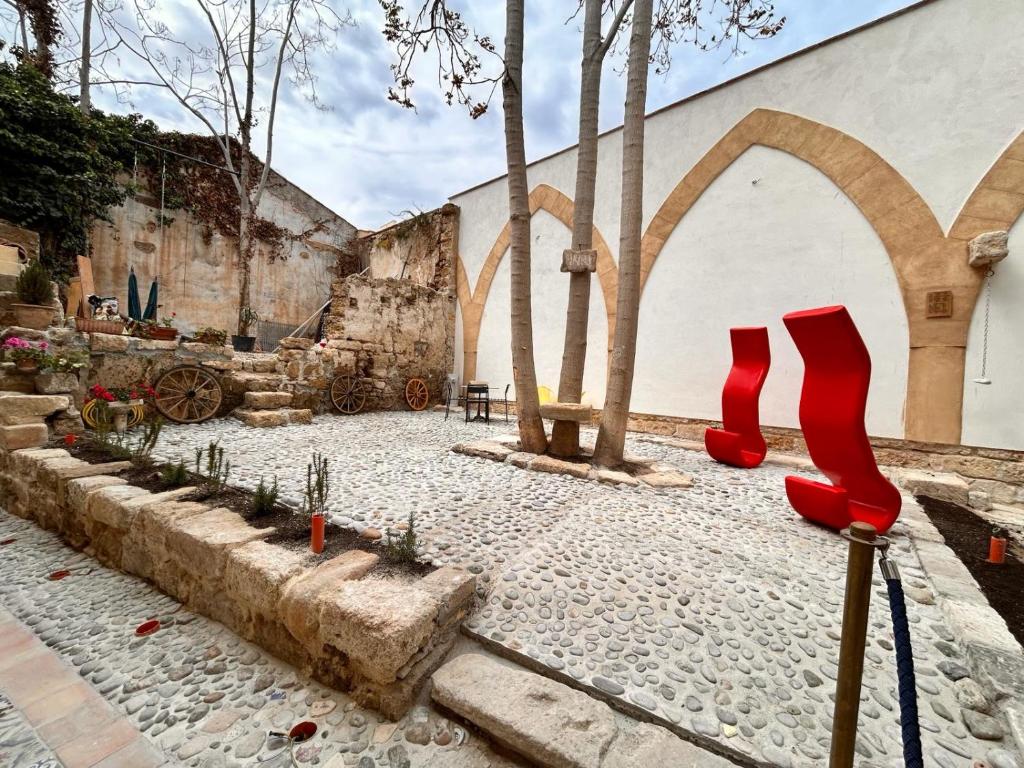 a pair of red high heel shoes on the ground at Khalisah in Palermo