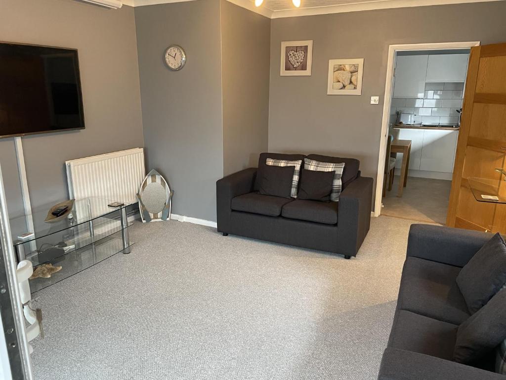 a living room with a couch and a chair at 1-Bedroom Apartment Sleeps 4 Parking in Hythe