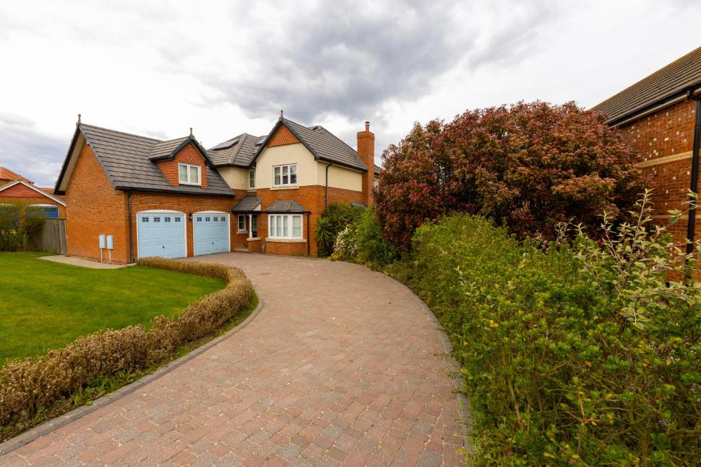 a brick driveway in front of a house at Supreme Class Properties in Eastchurch