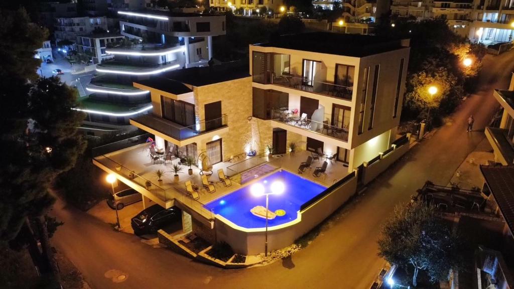 an aerial view of a house with a swimming pool at night at Arte Luxury Pool Apartmets in Ulcinj