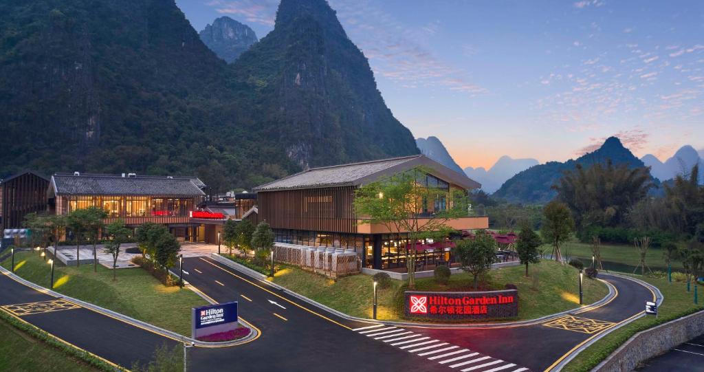 a rendering of a building in front of a mountain at Hilton Garden Inn Guilin Yangshuo in Guilin
