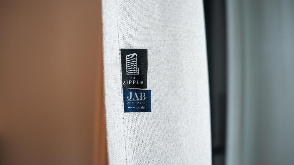a close up of a white book with a black label at The Zipper Hotel und Apartments in Düsseldorf