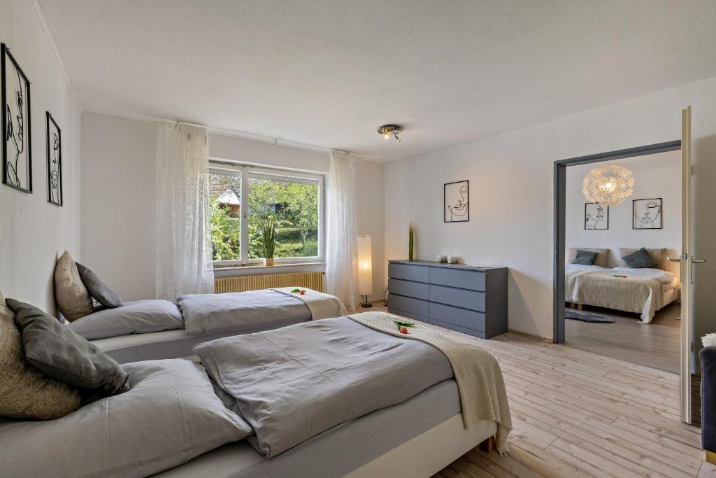 a large bedroom with two beds and a couch at Apartment Alb Glück 1 in Hechingen
