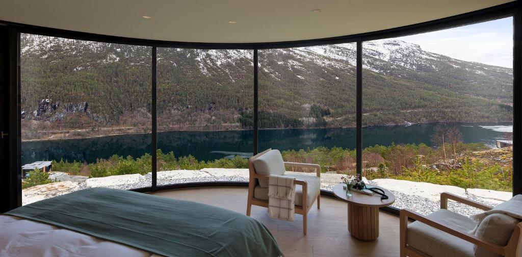 a bedroom with a bed and a view of a mountain at Sogndal Fjordpanorama- The Panorama View in Kaupanger
