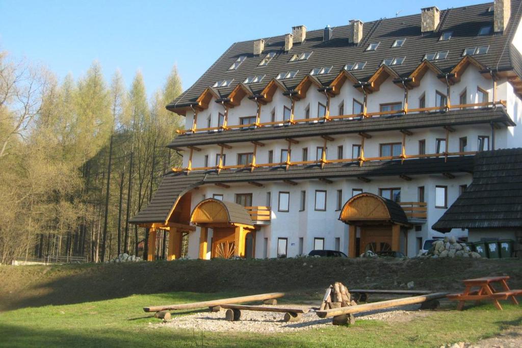 a large white building with a gambrel roof at OW Zakopiec in Zakopane