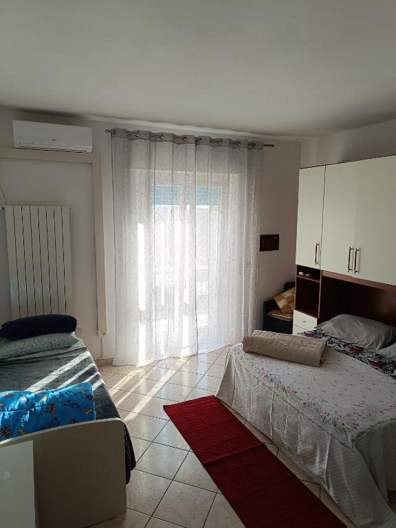 Posteľ alebo postele v izbe v ubytovaní L'appartamento delle vacanze