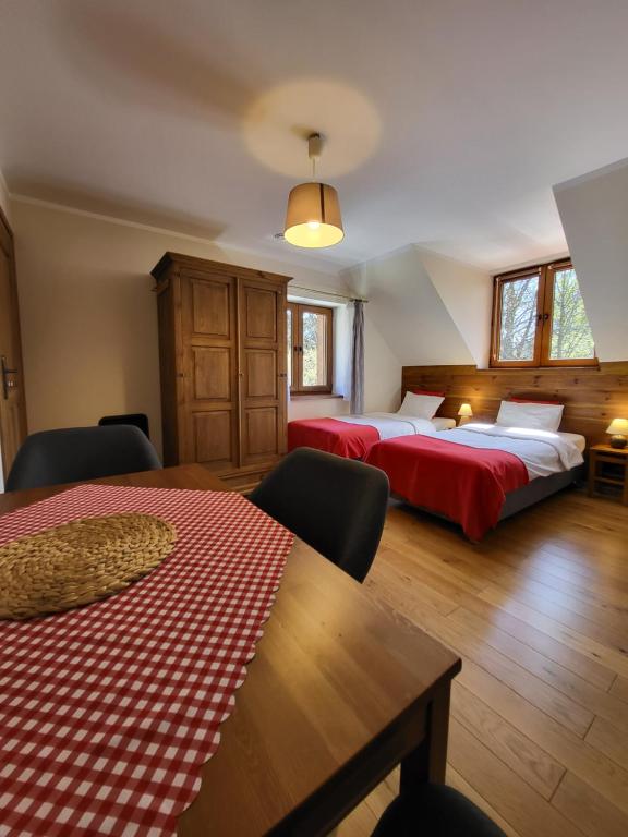 a hotel room with two beds and a table at To Tutaj in Szklarska Poręba