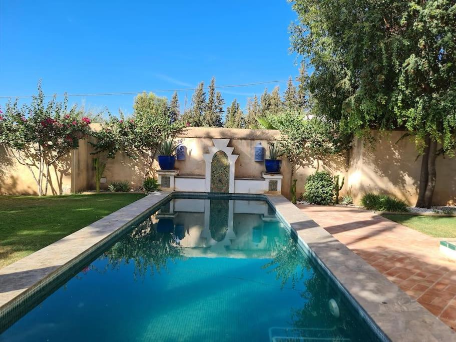 a swimming pool in the yard of a house at Andalusische Villa in Mairena del Aljarafe