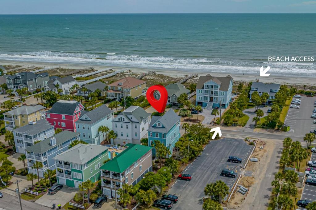 an aerial view of a beach with houses and a red marker at Luxury Beach House Ocean AND Inlet Views in Myrtle Beach