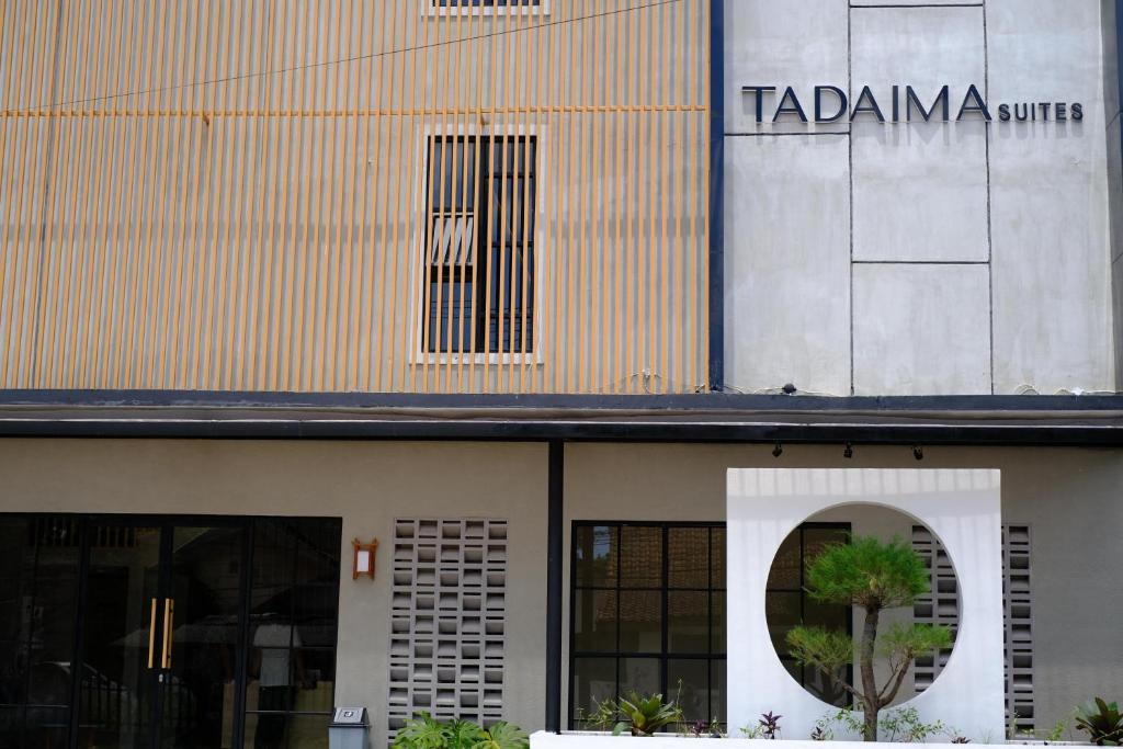 a building with a sign on the side of it at Tadaima Suites Cilegon in Cilegon