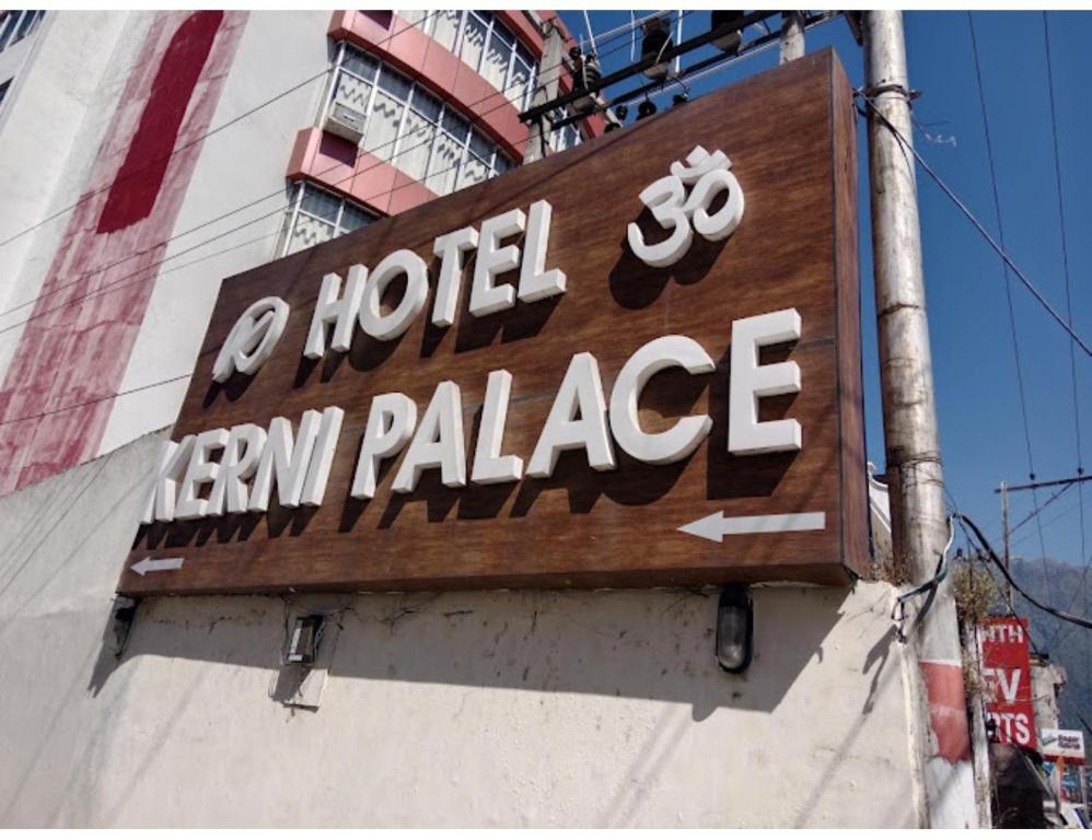 a sign for a hotel entry palace on the side of a building at Hotel Kerni Palace, Katra in Katra