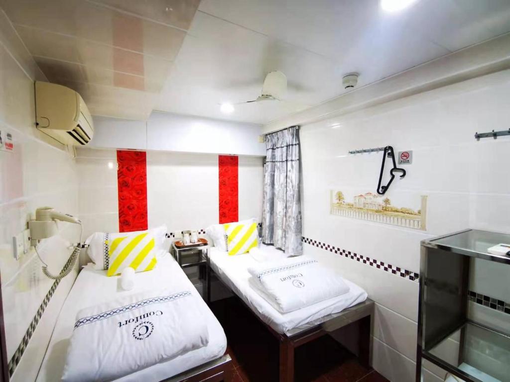 Postel nebo postele na pokoji v ubytování New Peking Guest House
