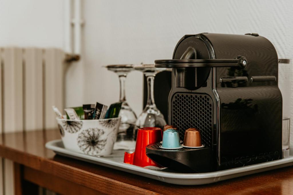 a tray with a coffee maker on a table at Hôtel L&#39;Iroko The Originals City in Aix-les-Bains