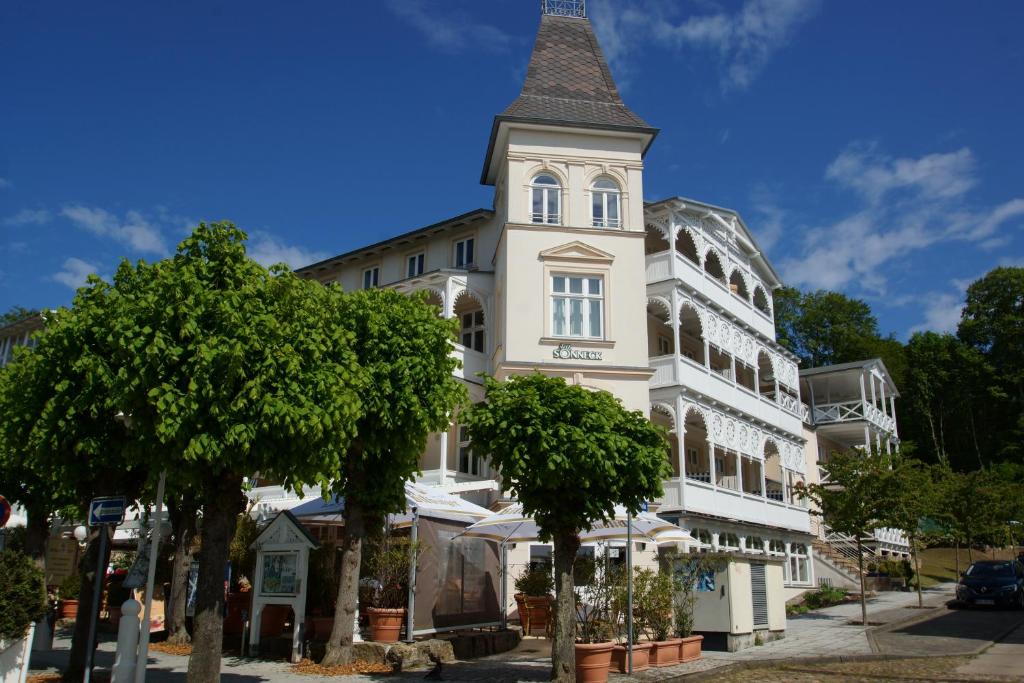 a tall white building with a tower on top at Baltic Sun W6 in der Villa Sonneck in Ostseebad Sellin