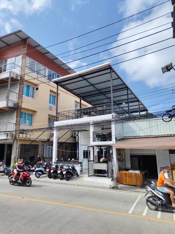 a group of motorcycles parked in front of a building at @888byChefKong in Ko Tao