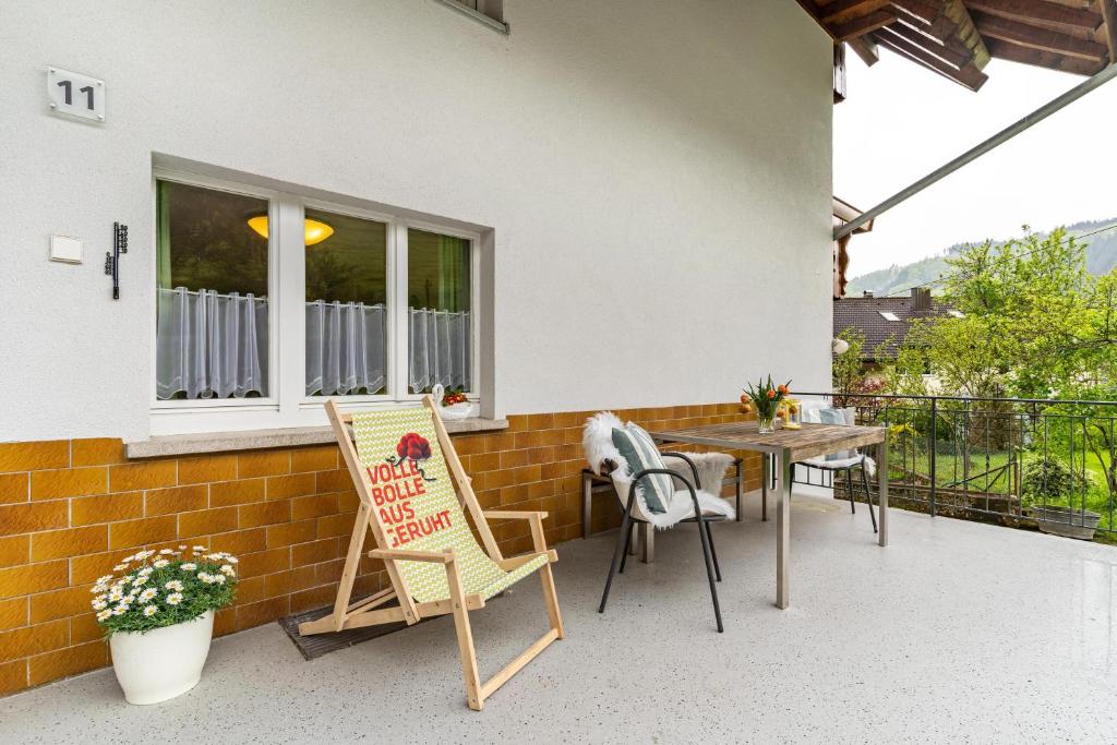 a patio with chairs and a table and a window at Ferienwohnung zum Pavillon in Mühlenbach