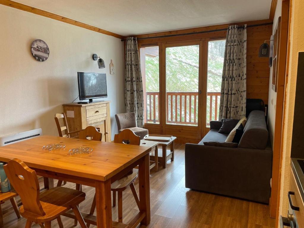 uma sala de estar com uma mesa e um sofá em Appartement Valloire, 3 pièces, 5 personnes - FR-1-263-224 em Valloire