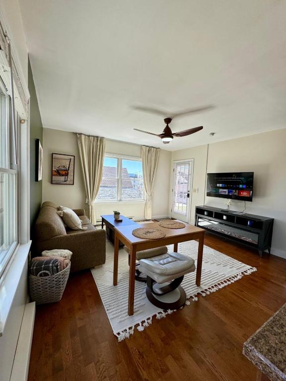 a living room with a table and a couch at Central Lake Placid Hideaway in Lake Placid