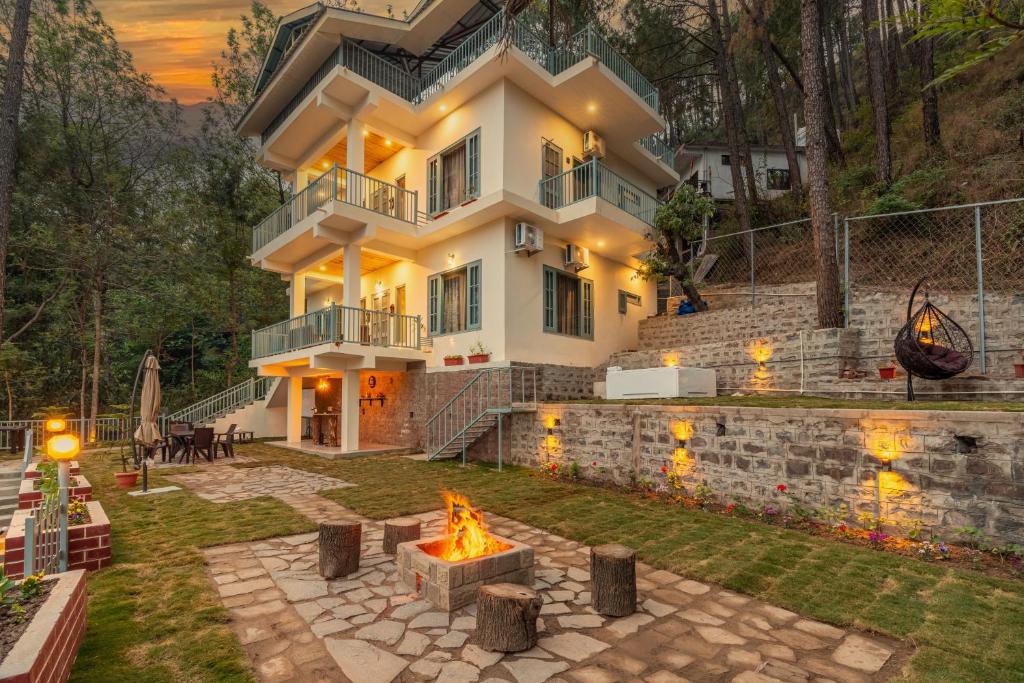a house with a fire pit in the yard at SaffronStays Naaz in Kasauli