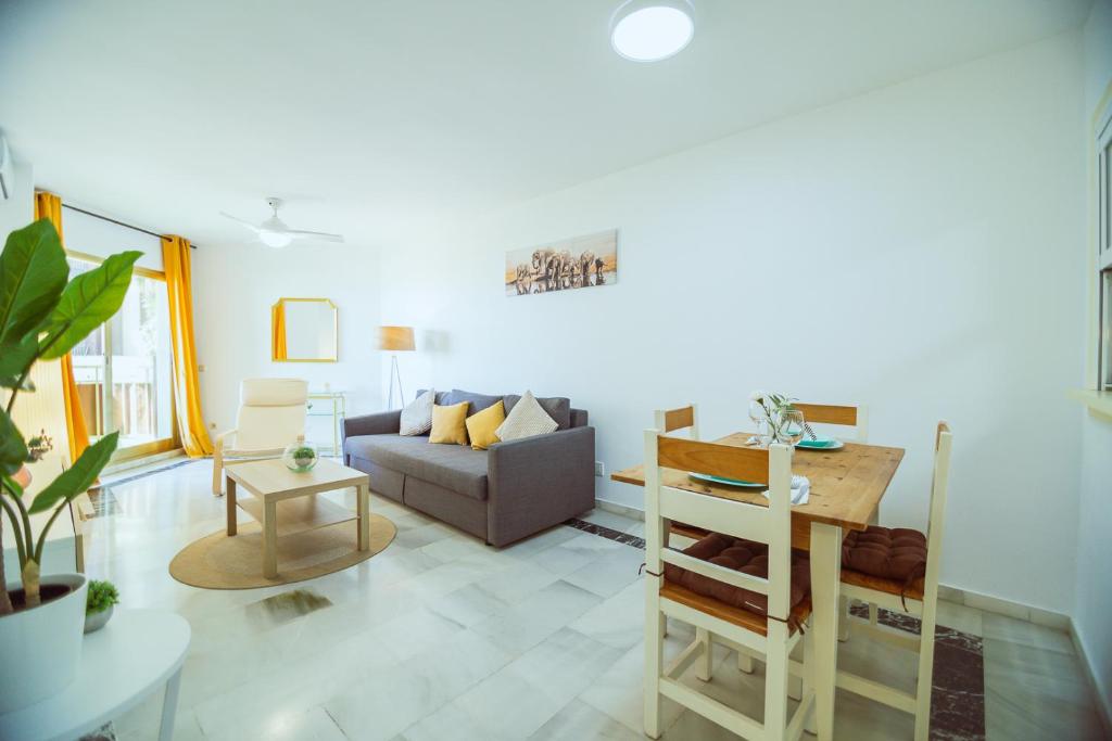 a living room with a couch and a table at Sol & Mar apartment in Fuengirola