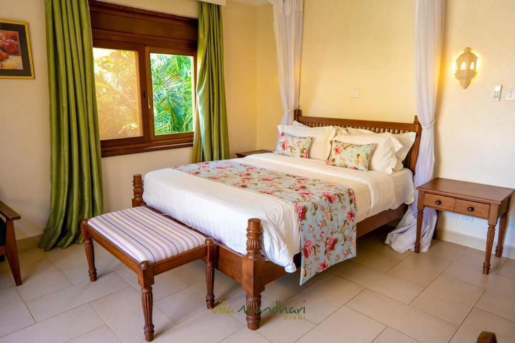 a bedroom with a bed and a window at Villa Mandhari - Diani Beach in Diani Beach
