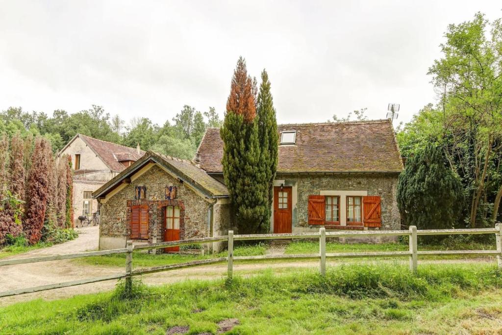 una casa vieja con una valla delante de ella en Maison de 2 chambres avec jardin amenage et wifi a Raizeux, en Raizeux