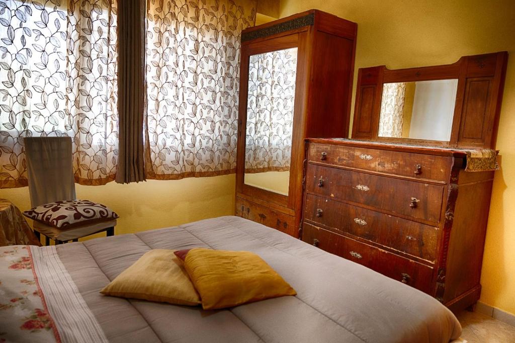 a bedroom with a bed with a dresser and a mirror at VILLA SOFIA in Montenero di Bisaccia