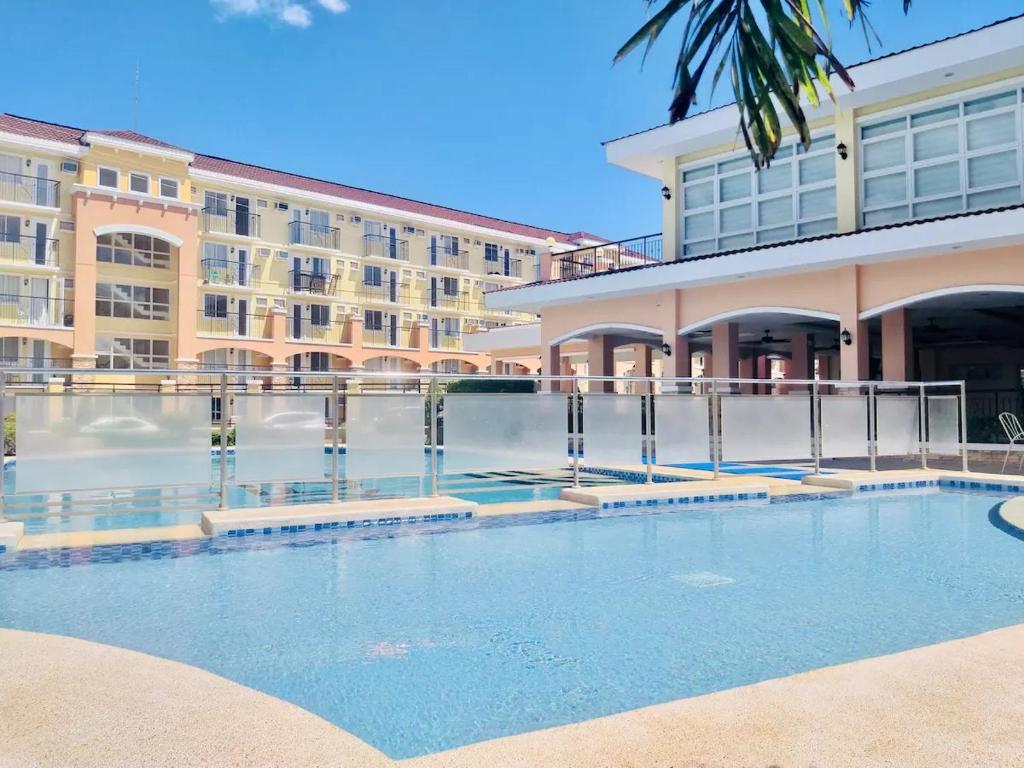 a swimming pool in front of a building at Areezo Condo buhangin City Davao in Davao City