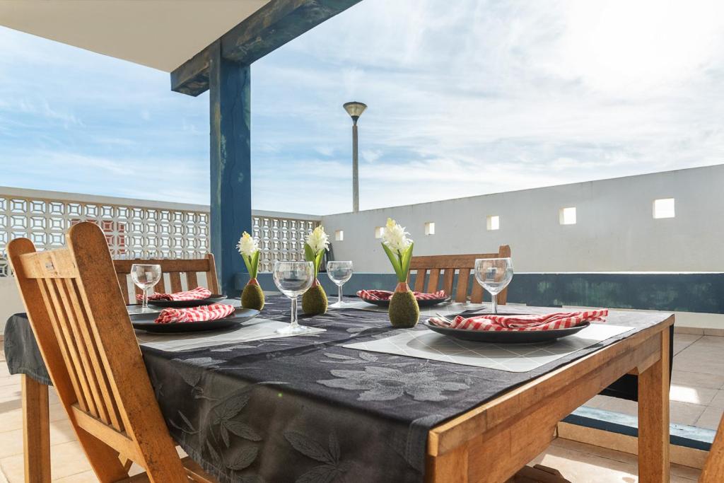 a table with a black table cloth and wine glasses at BLife Bandaya private apartment in Faro