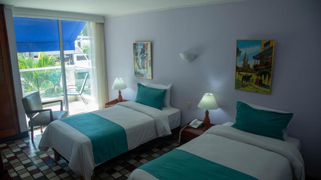 Postel nebo postele na pokoji v ubytování Hotel Bahia Cartagena