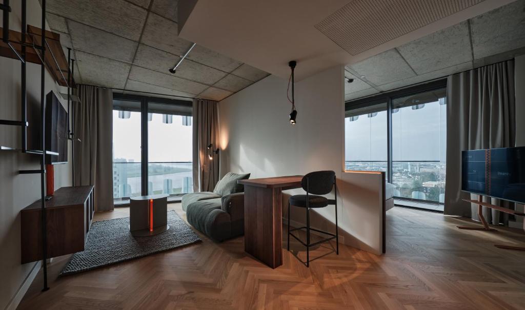 a living room with a couch and a table at The Zipper Hotel und Apartments in Düsseldorf